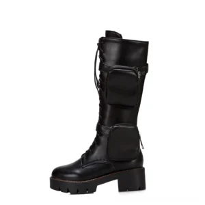 Black women's gothic mid-calf combat boots with dual zippered pockets and block heel, side profile view