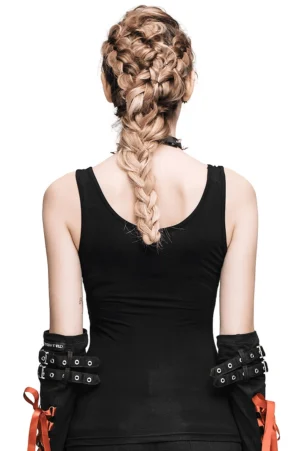 Back view of black gothic spike tank top showing low-cut design and studded arm cuffs with orange tie details, worn by model with braided hair