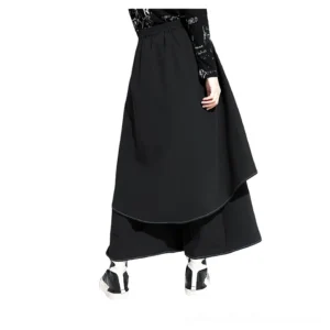 Black wide leg gothic pants rear three-quarter view displaying layered skirt design, elastic waistband, and back drape construction