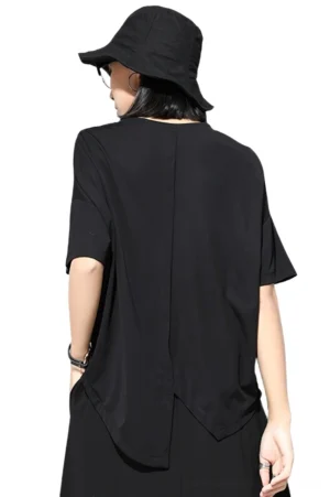Black gothic T-shirt back view on model, showcasing drop shoulders and curved asymmetric split hem detail