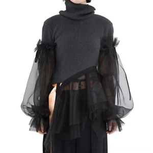 Black gothic turtleneck sweater with sheer mesh puff sleeves and asymmetrical hem, front view worn by model