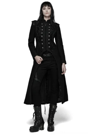 Black gothic double-breasted wool coat front view on model, showing symmetrical pointed lace trim and embossed skull rivets, floor-length fitted silhouette with dramatic A-line hem