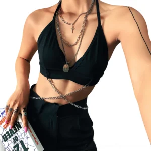 Black halter crop cami top with layered silver body chain and cross necklaces on female model, front close-up view
