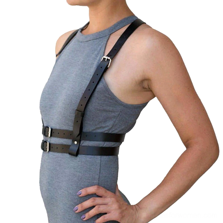 Women's black faux leather chest harness belt, side profile view demonstrating snug torso fit, metal buckle closure, alternative fashion harness
