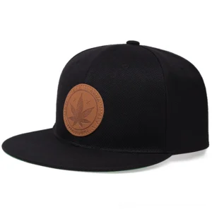 Black gothic hemp leaf snapback cap front view with embossed leather patch detail