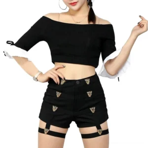 Black high-waist shorts with gold leopard metal buttons and detachable thigh harness straps worn by model, front three-quarter view