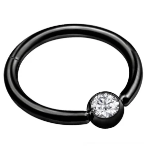 Black hinged clicker nose ring flat lay close-up - polished stainless steel segment hoop with cubic zirconia crystal accent