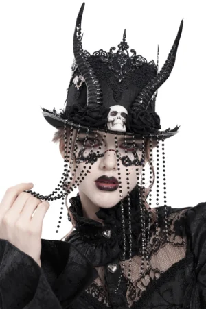 Gothic black horned top hat with beaded veil, skull centerpiece and devil horns worn by model with gothic makeup - front close-up view