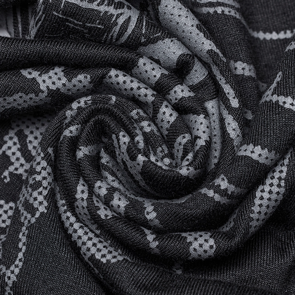 Macro close-up of soft black stretch knit fabric texture with subtle skeleton pattern showing fabric composition quality