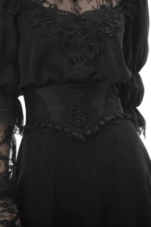 Black gothic corset belt with floral lace appliqué and front ribbon lace-up closure worn over a Victorian-style black blouse, studio close-up detail view
