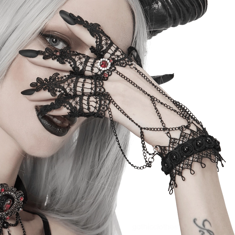 Black lace fingerless gothic gloves showcasing the intricate hollow floral pattern and chain embellishments in artistic flat lay photography
