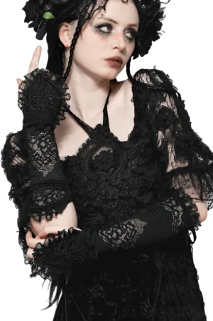 Black lace fingerless gothic gloves with ruffled cuffs worn on model in front three-quarter studio view, showing intricate floral lace detailing and romantic cuff design