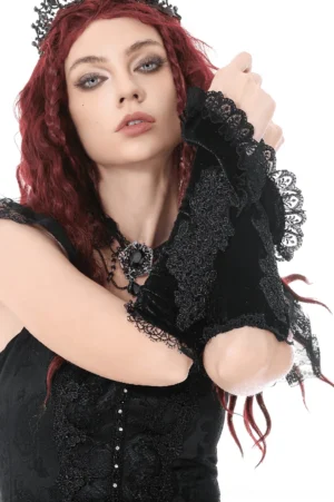 Close-up front view of black lace gothic arm warmers with intricate floral embroidery and velvet ruffle cuffs on model