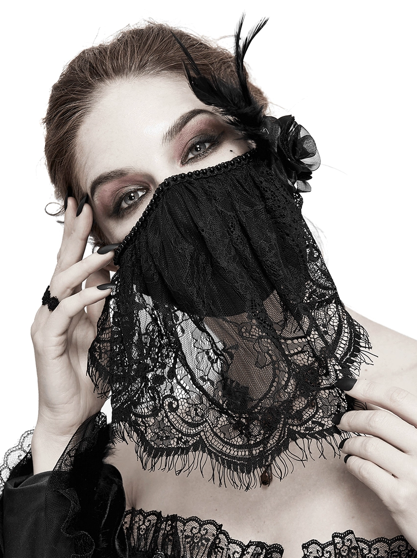 Black lace gothic face veil mask with feather and rose embellishments, worn by fashion model in front studio view