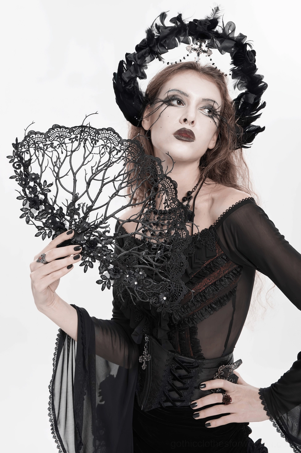 Black gothic hand fan with intricate lace work and floral branch detail showing dimensional depth and openwork pattern