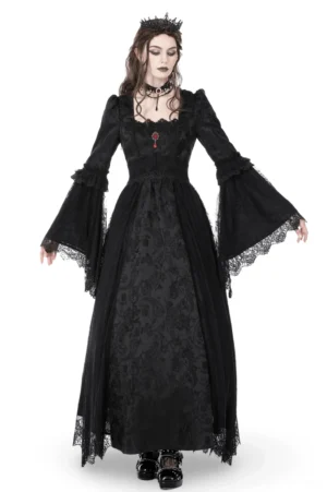 Black gothic long-sleeve lace maxi dress with red gem brooch worn by female model in studio, front three-quarter view showcasing square neckline and bell sleeves