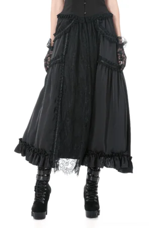 Black gothic lace panel maxi skirt front view with sheer lace overlay and ruffled hem, modeled by female in goth attire