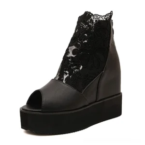 Black gothic lace platform sandals with peep-toe and floral ankle mesh detail, three-quarter front view showcasing hidden wedge construction