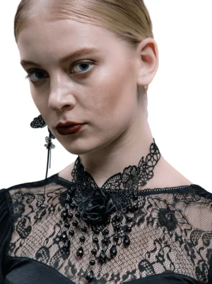 Black lace rose gothic choker necklace front view on blonde model, featuring delicate lace collar with dangling black crystal beads and fabric rose accent