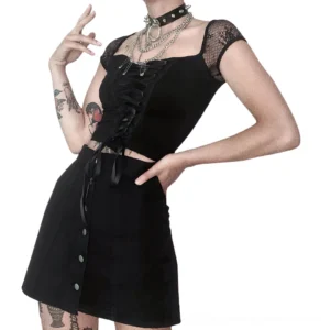 Black gothic lace-up crop top paired with mini skirt worn by tattooed female model in streetwear style three-quarter view