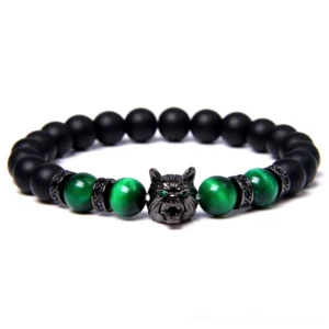 Black lava stone wolf charm beaded bracelet with matte onyx and green tiger eye stones, gothic animal symbol jewelry flat lay