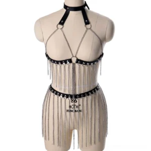 Black leather body harness with silver chain tassels front view, featuring halter neck collar and adjustable buckles on dress form mannequin