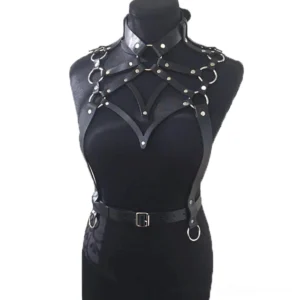 Black synthetic leather body harness front view - featuring crisscross chest straps with metal O-rings and buckles on dress form mannequin
