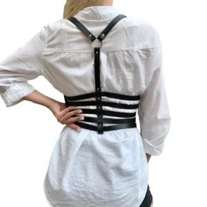Black PU leather harness rear view showcasing Y-shaped back strap and O-ring buckle detail with metal hardware