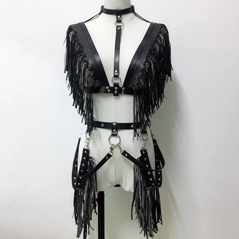 Dress form showing black leather chest harness with waist straps, metal D-rings, and adjustable tassel details, three-quarter angle
