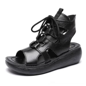 Black leather gladiator platform sandals with lace-up high-top design and hollow strap cutouts, three-quarter view showcasing peep toe gothic aesthetic