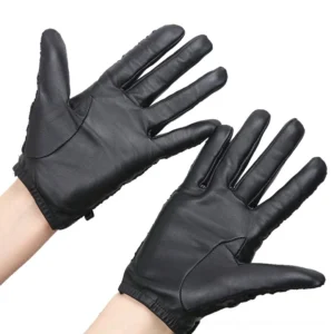 Genuine black leather gloves with smooth texture and wrist strap, front close-up view on white background