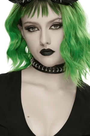 Black leather gothic choker with metal ring details worn by model with green hair, studio front view