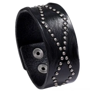 Black leather gothic cuff bracelet with cross rivet pattern and snap buckle closure, front oblique view on white background