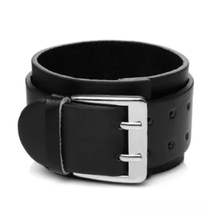 Black genuine leather gothic cuff bracelet with wide design and silver dual-prong buckle, adjustable sizing holes, smooth leather texture, studio close-up view