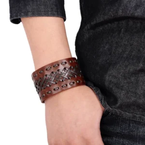 Black braided leather gothic cuff bracelet worn on wrist with denim, showing adjustable snap closure and woven exterior design