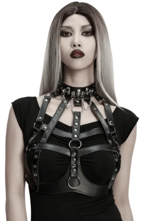 Black gothic leather chest harness with skull studs worn by model front view