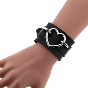 Black leather double-strap heart cuff bracelet with silver iron alloy heart detail, shown on mannequin hand from overhead angle