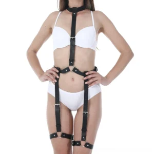 Black leather body harness front view - minimalist gothic waist and thigh strap with metal buckles on female model