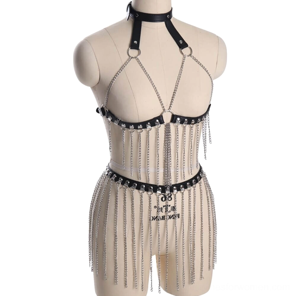 Three-quarter front view of black leather body harness featuring crossed front metal straps and integrated waist chain tassels