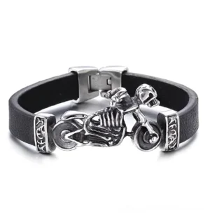 Black leather motor skull biker bracelet with stainless steel skeleton motorcycle charm and Celtic clasp detail, front view on white background