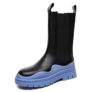 Black leather gothic platform chelsea boots with wavy electric blue chunky sole, front three-quarter view showing elastic side panels and pull tabs