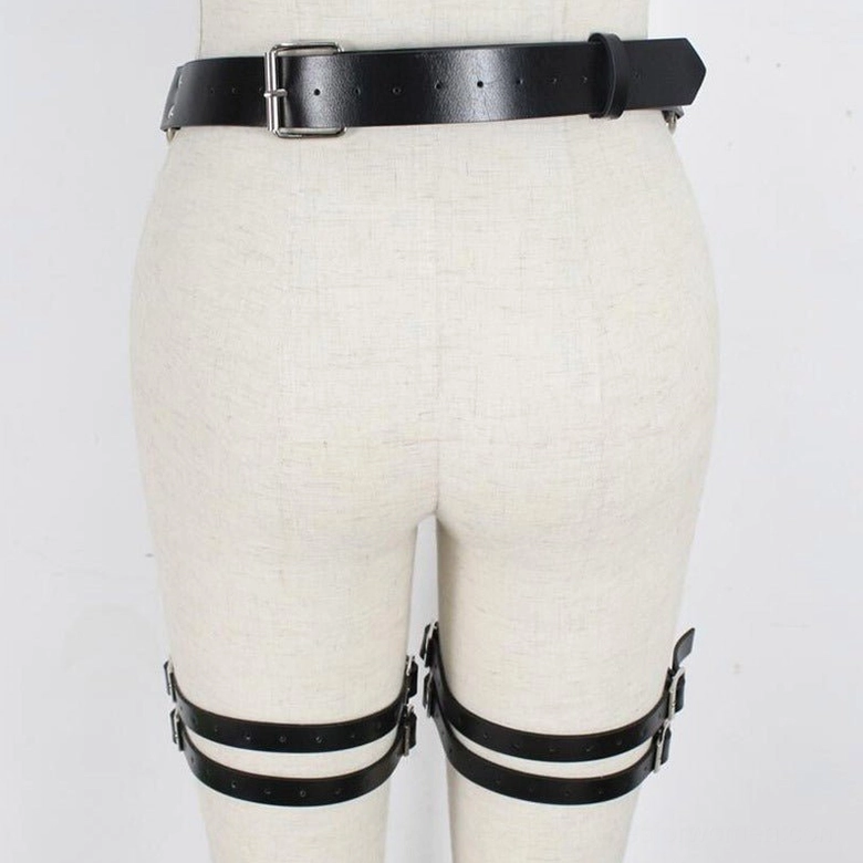 Black leather double thigh garter harness rear view with silver pin buckle on fabric mannequin, showing back strap construction