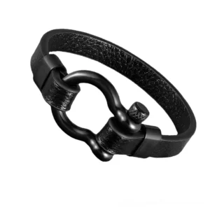 Black matte leather toggle clasp bracelet with stainless steel geometric hardware, oblique side view showcasing industrial gothic design