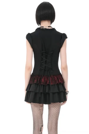 Back view of Gothic Lolita dress with crisscross lace-up corset detailing and tiered ruffled skirt worn with fishnet stockings