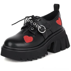 Matte black PU leather platform lace-up pumps featuring red heart appliqué and chunky rubber lug sole, side angle