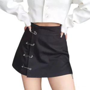 Black low-waist A-line mini skirt with safety pin decorations worn with white cropped top, front model shot