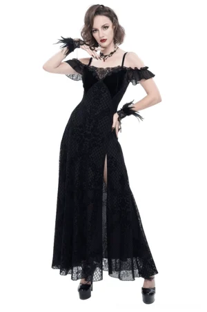 Black off-shoulder gothic lace maxi dress with velvet neckline and side slit worn by model, front three-quarter view with feather ornaments