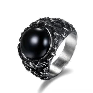 Black onyx gothic stainless steel signet ring overhead close-up view showing polished gemstone and carved metal frame
