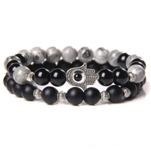 Black onyx beaded bracelet with gray stone and silver Hamsa evil eye charm - gothic minimalist style flat lay