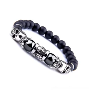 Black onyx gothic bracelet side angle detail showing engraved skull metal accents and matte stone finish